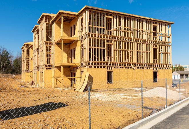 a close-up of temporary chain link fences enclosing a construction site, signaling progress in the project's development in East Rancho Dominguez